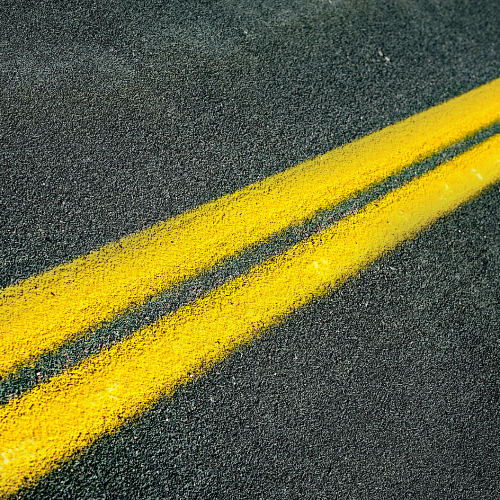 asphalt road with double yellow lines